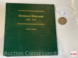 Coins - 1899o Silver Dollar, Morgan plus an empty Morgan Dollar storage binder for years 1892-1921