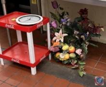 Coca Cola stand, faux flower displays, and clock