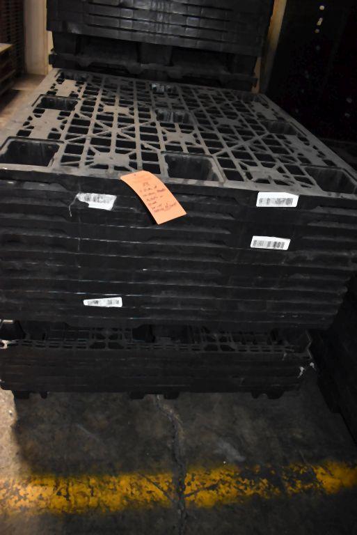 (4) STACKS OF NESTING PLASTIC PALLETS ON FLOOR,