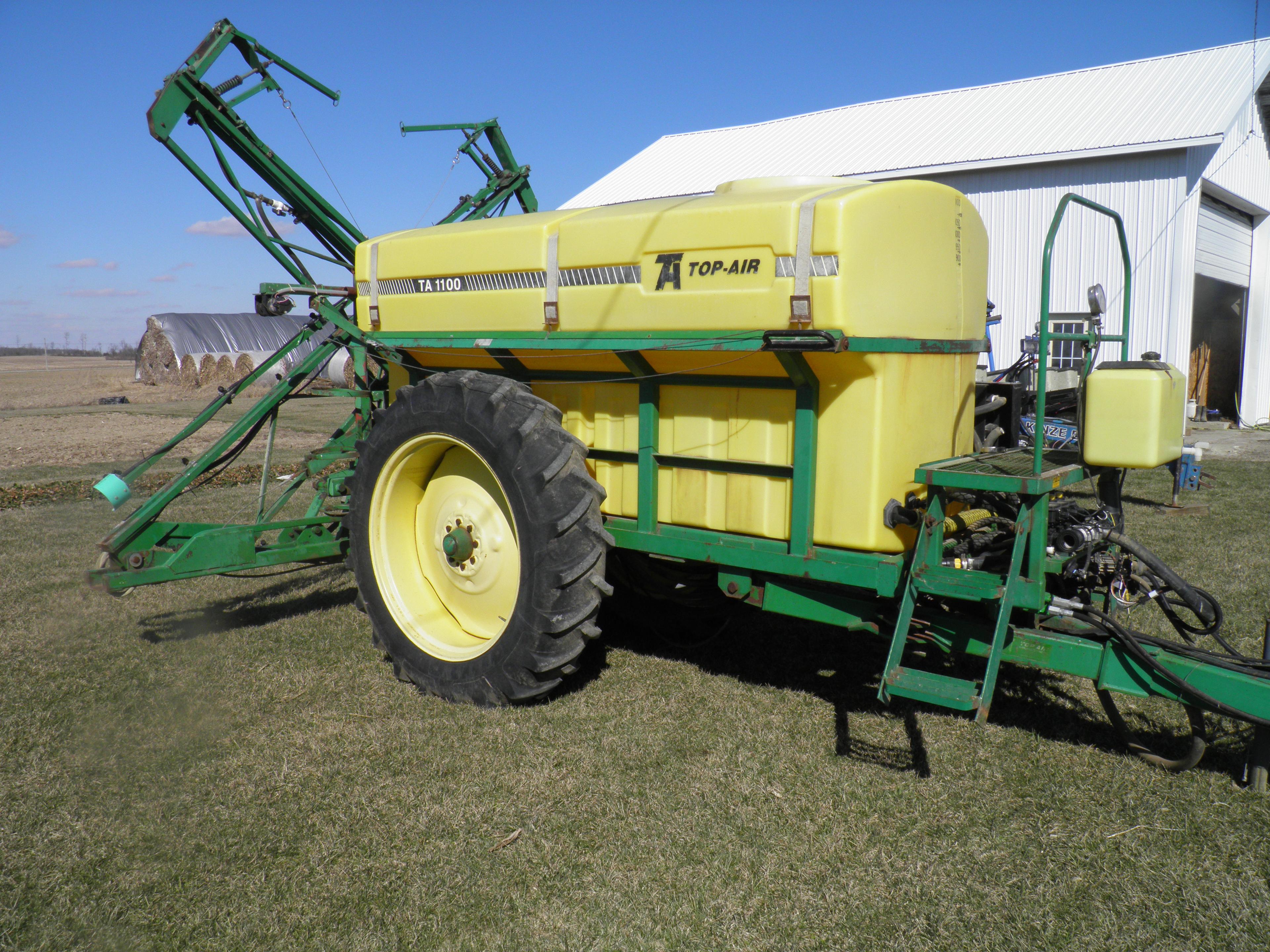 Top Air Model 1100 pull type sprayer, 60ft X-fold booms, 13.6-38 on 60in. c