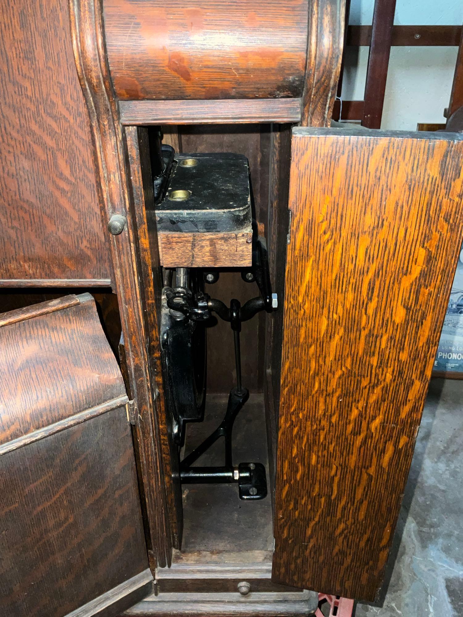 Singer Treadle sewing machine in oak cabinet