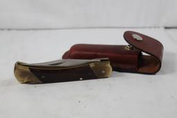 Schrade folding hunter model LB7. 3.75 inch blade. Wood scales. Original leather sheath. In good