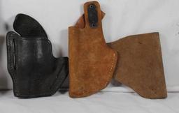 Four leather holsters. Used.