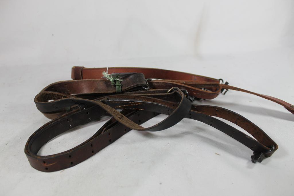 Three leather slings with swivel attachments. Used.