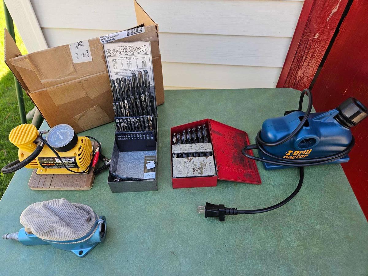 Drill bits / drill doctor, spark plug cleaner, and mini air compressor.