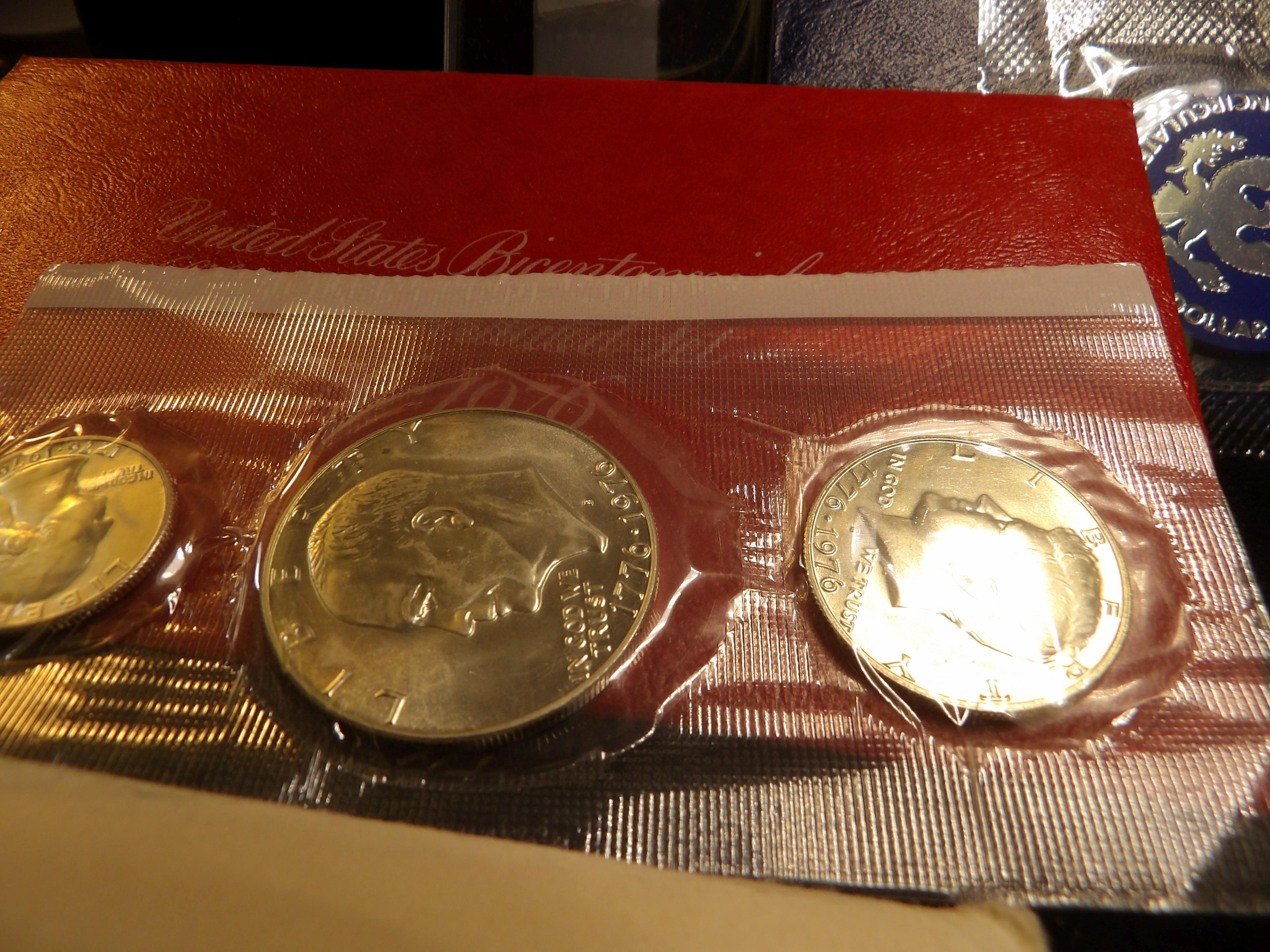 1976 Silver Bicentennial Uncirculated Three-piece Set; 1973 S Silver Uncirculated Eisenhower Dollar;