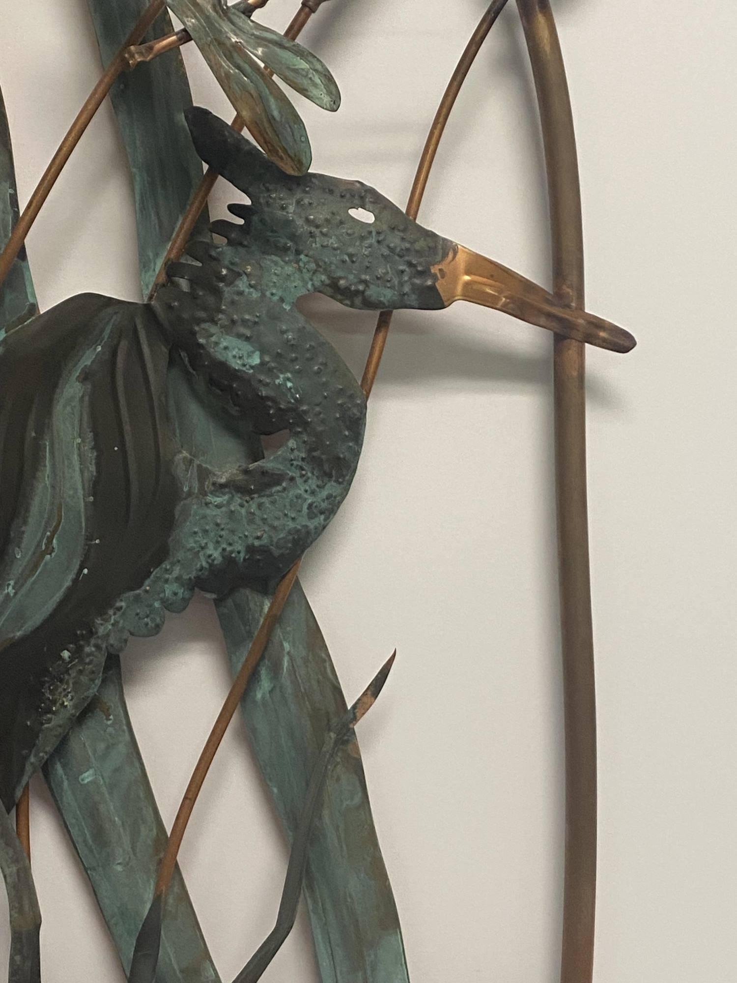 METAL SCULPTURE OF HERON IN THE MARSH