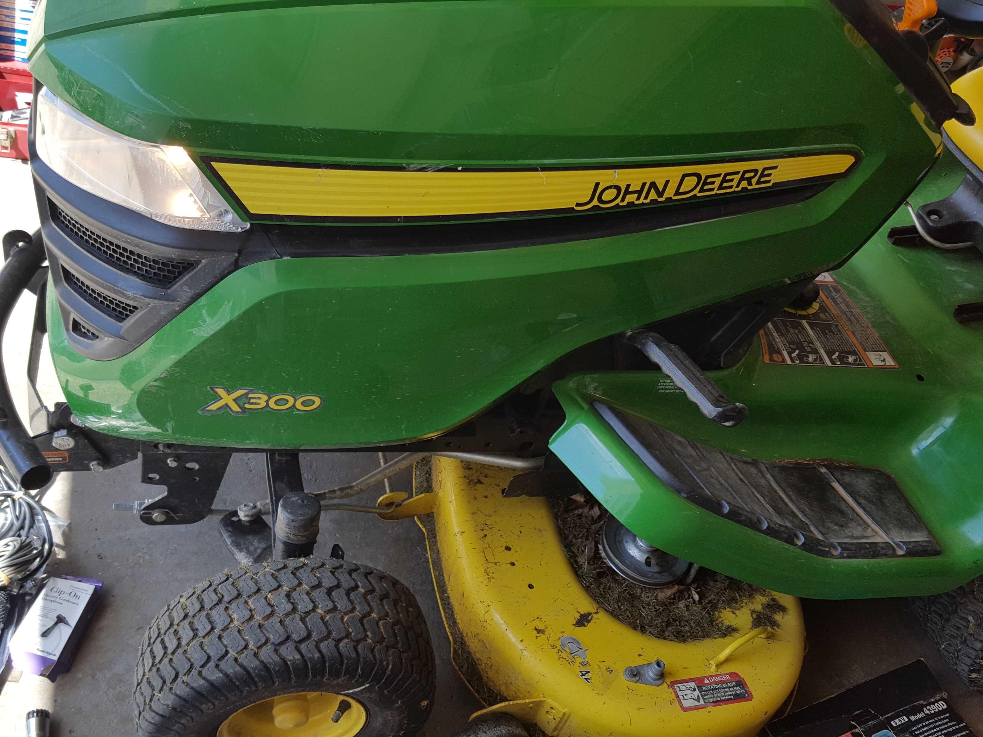 John Deere X300, 42 inch, riding mower with bagging system parts. needs delivery tube system for