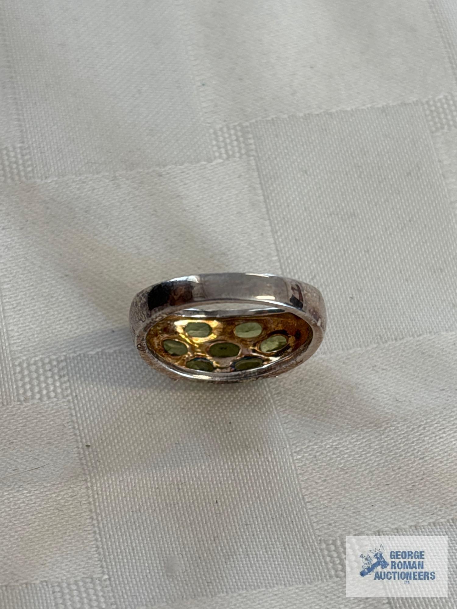Silver colored ring with green gemstones, marked 925, approximate total weight is 5.4 G