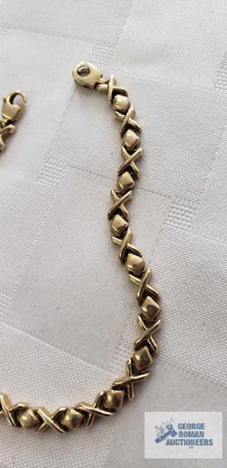 Gold colored X's and O's bracelet,...marked 14KT Italy, approximate total weight is 7.16 G