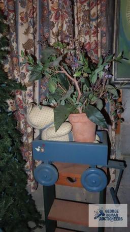 toy wooden wagon, artificial plant and wooden plant stand