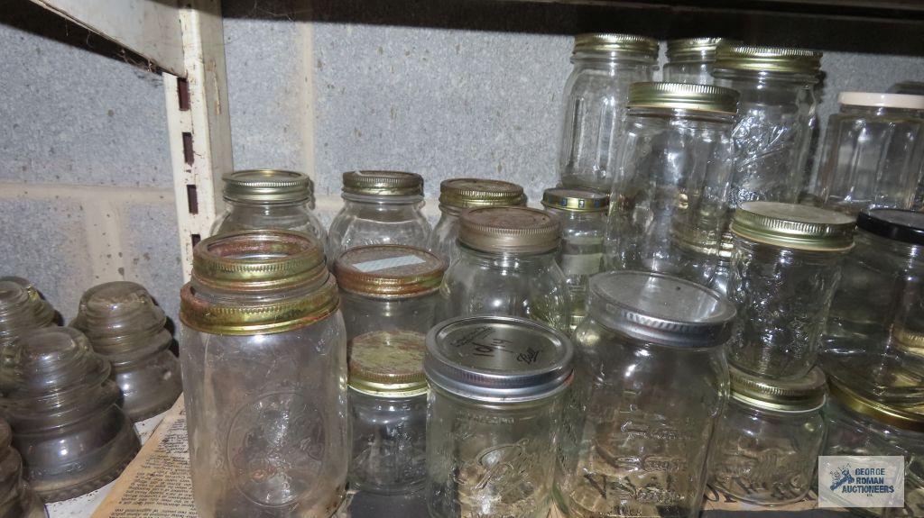 Two shelves of assorted jars