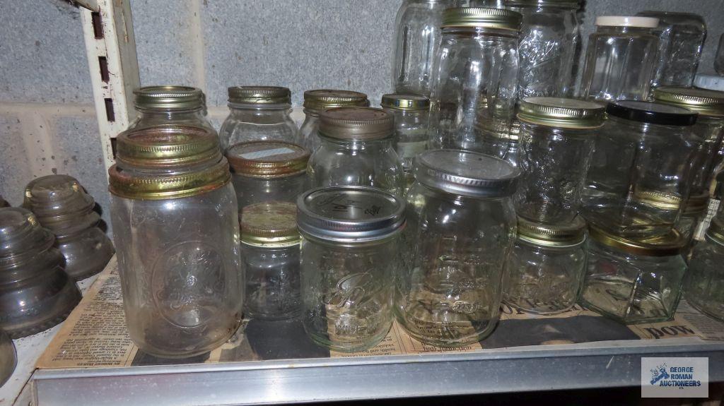 Two shelves of assorted jars