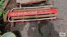 Two vintage sleds. One has damage.