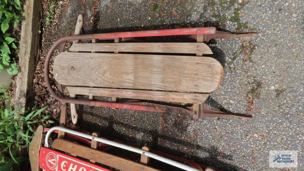 Two vintage sleds. One has damage.