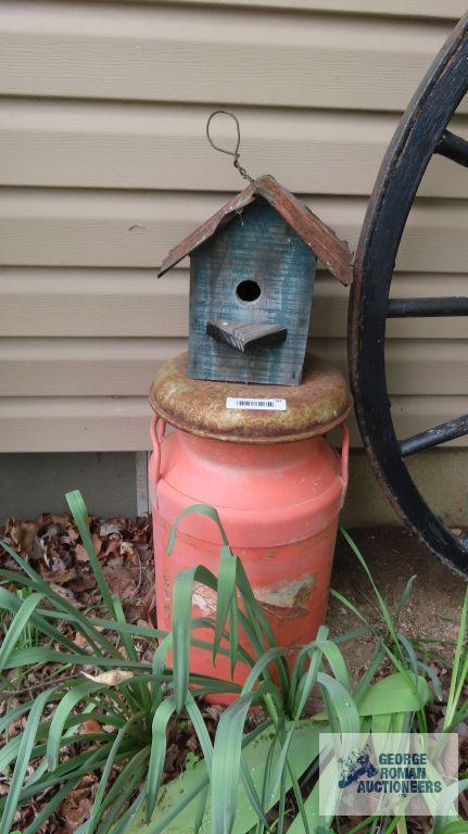 Orange milk can with birdhouse