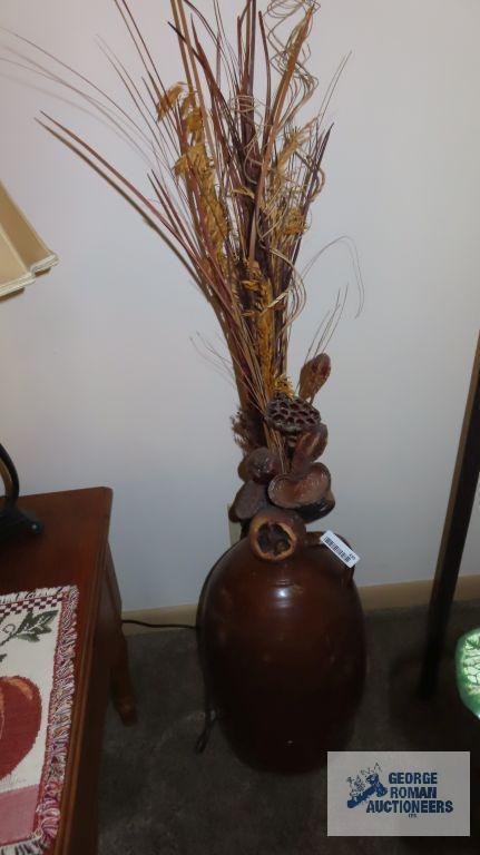 Large brown crock with artificial plants