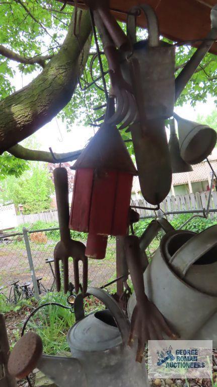 Lot of antique watering cans and birdhouse