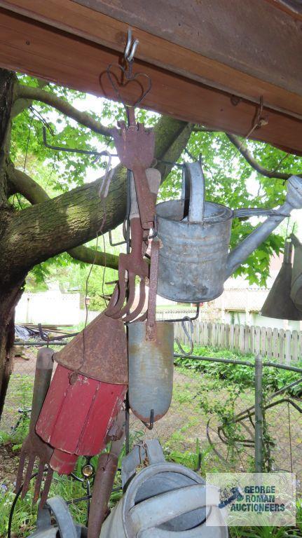 Lot of antique watering cans and birdhouse