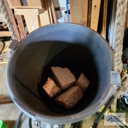 Metal bucket with antique pulley and plastic planter