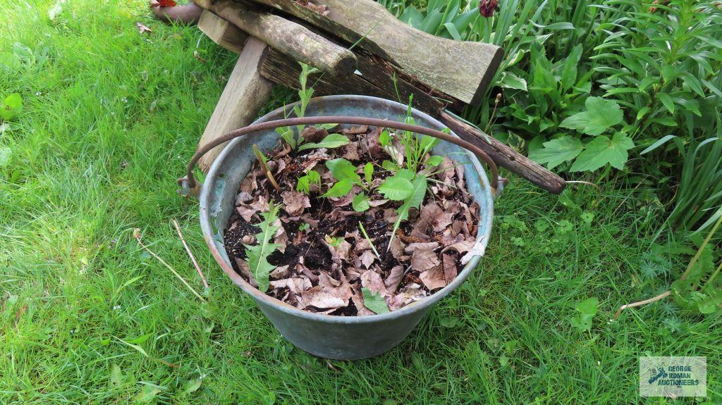 Antique wheelbarrow with copper bucket