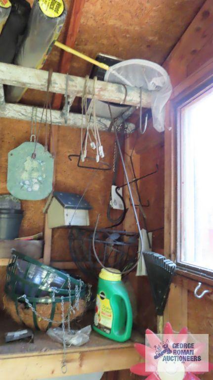 Contents of outhouse including hanging baskets, plastic planter inserts, small plant hooks, garden