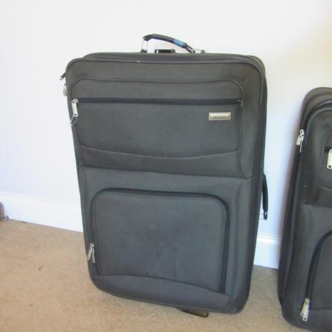 Two Black Soft Side Protocol Rolling Suitcases