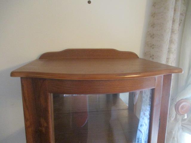 Illuminated Oak Bow Front Curio Cabinet with Mirrored Back