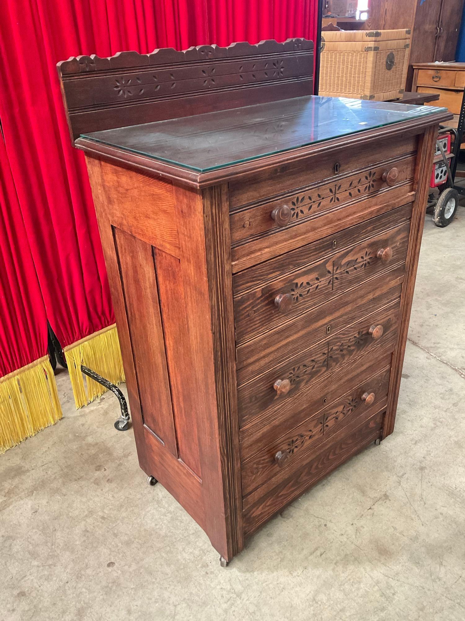 Antique Wooden Wheeled Glass Topped Dresser w/ 4 Drawers & Carved Floral Patterns. See pics.