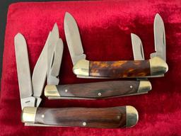 Trio of Buck Folding Knives, models 371 Stockman, 384 Trapper, 389 Canoe, stainless steel blades