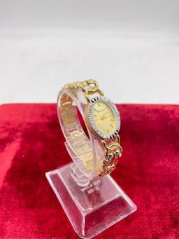 Women's Bulova 14k gold case and 14k band wristwatch w/16 diamonds, swiss quartz movt.