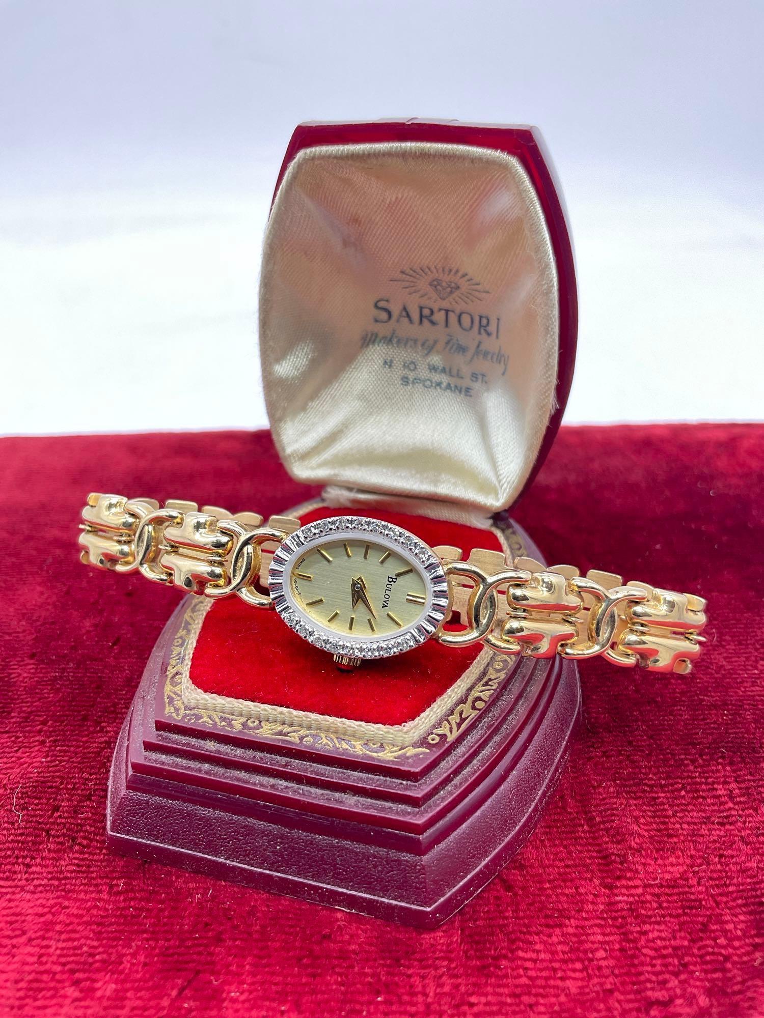 Women's Bulova 14k gold case and 14k band wristwatch w/16 diamonds, swiss quartz movt.