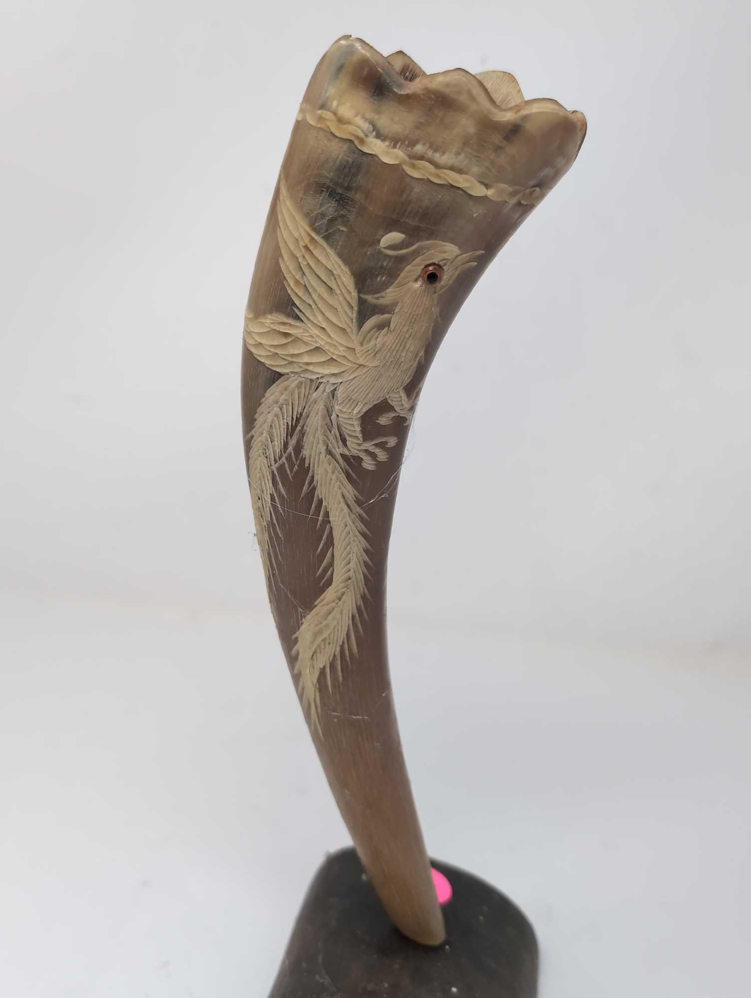(LR) VINTAGE CARVED PHOENIX DETAILED HORN ON CURVED HORN STAND. IT MEASURES APPROX. 3" X 3" X 11"