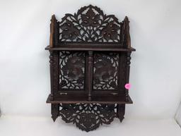 (LR) ANTIQUE ORNATE CARVED WOOD INDIAN FOLDING WALL SHELF WITH LEAF AND FLORAL DETAILING. IT