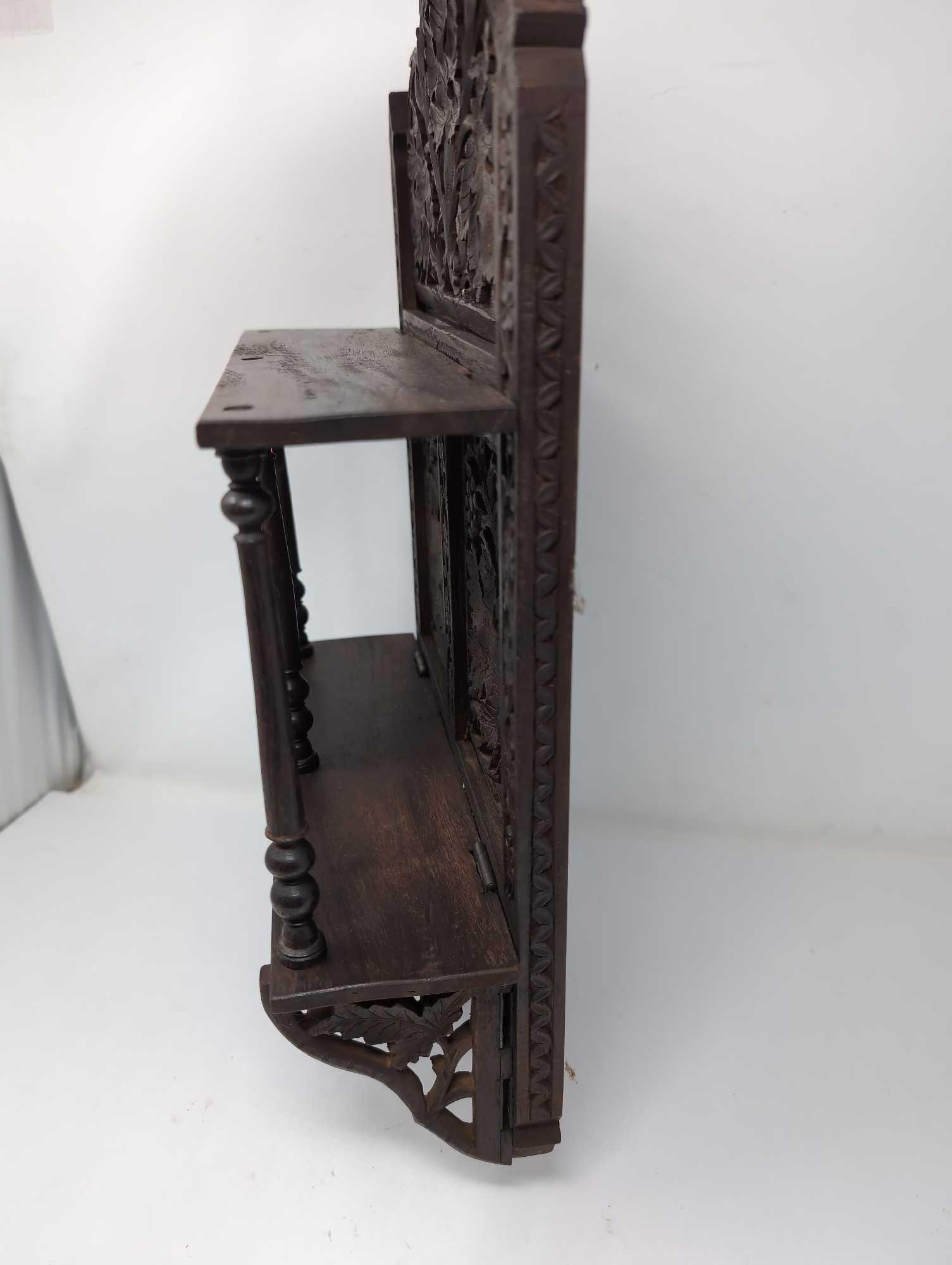 (LR) ANTIQUE ORNATE CARVED WOOD INDIAN FOLDING WALL SHELF WITH LEAF AND FLORAL DETAILING. IT