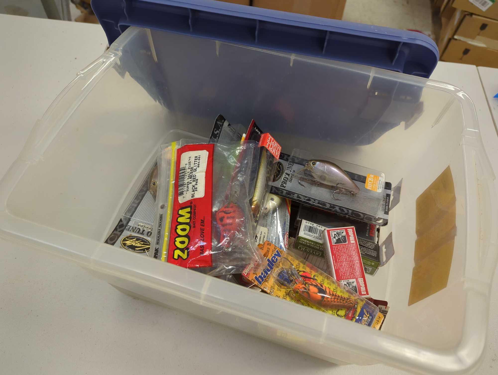 Blue tote organizer and contents including various fishing lures of similar style. Comes as is shown