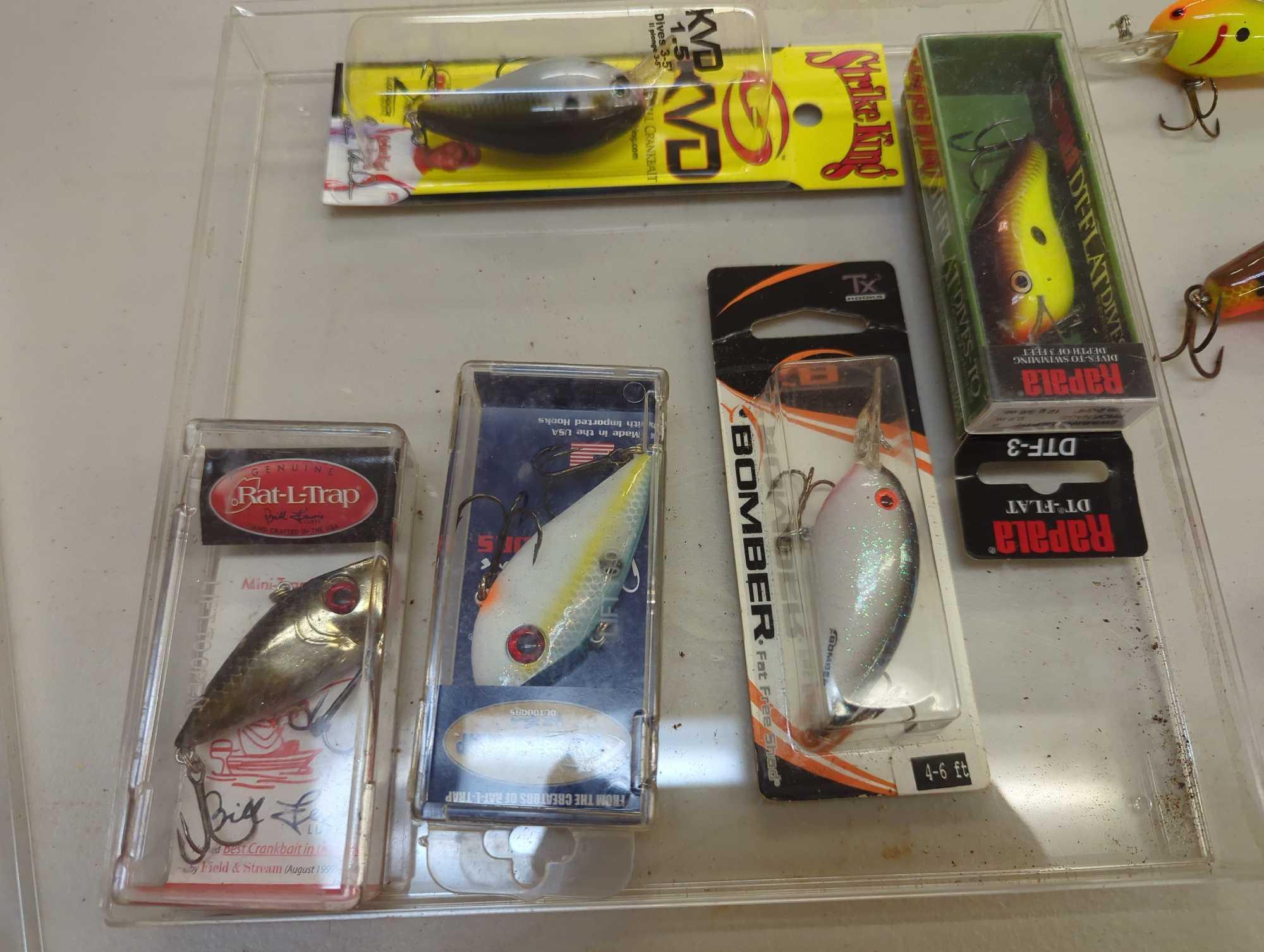 Clear chocolate box of fishing lures of similar style. Comes as is shown in photos. Appears to be