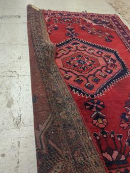 HAND MADE ANTIQUE AREA RUG. FLORAL ACCENTS, RED, AND DARK BLUE. 44 1/2"X60"
