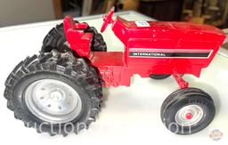 Toys - Ertl brand International Harvester red tractor and Hubley red trailer