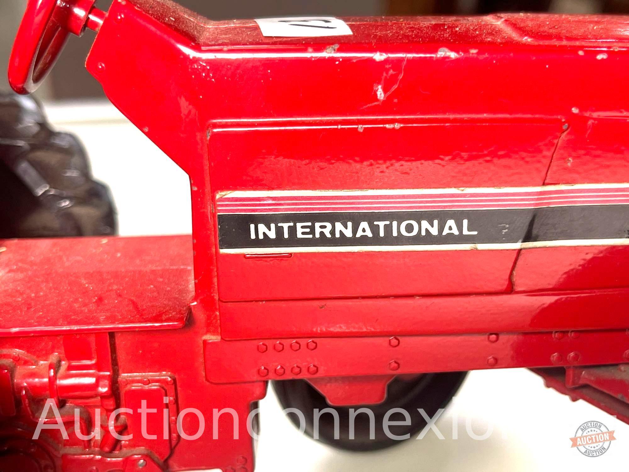 Toys - Ertl brand International Harvester red tractor and Hubley red trailer