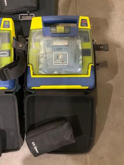 4 CARDIAC SCIENCE AUTOMATED EXTERNAL DEFIBRILLATORS & 1...CARDIAC SCIENCE AED TRAINER