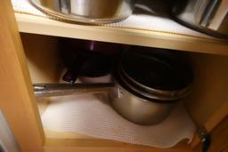 CONTENTS OF TWO DRAWERS AND TWO CABINETS FLATWARE LINENS POTS AND PANS