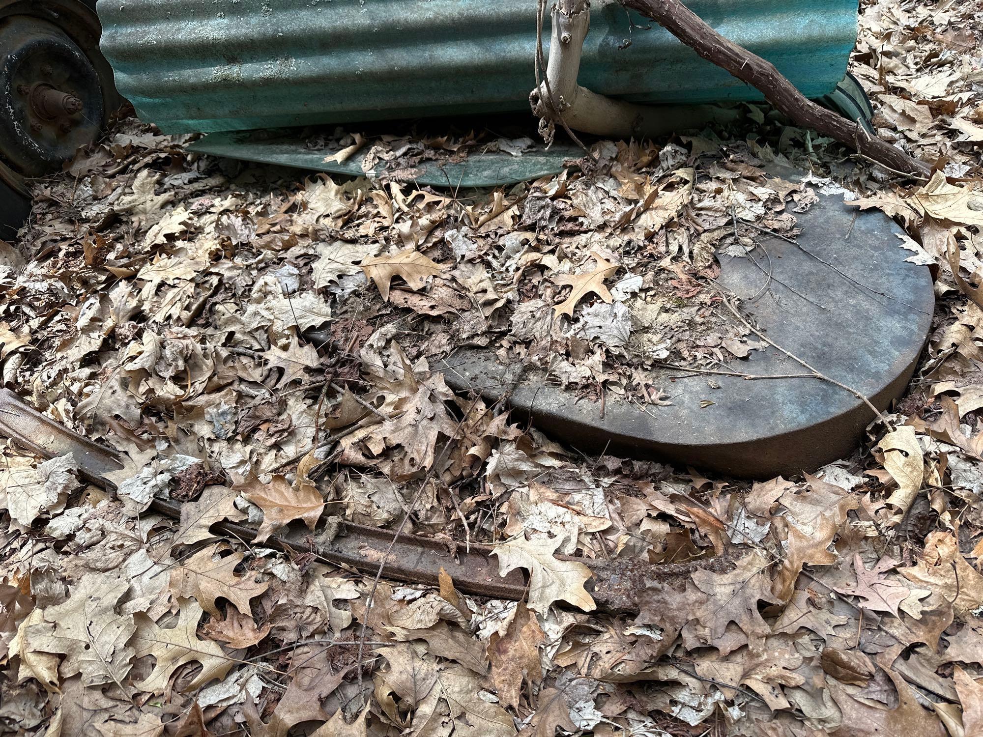 air conditioner - grease can - iron and parts behind garage