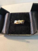 Lady's 18k yellow and white gold hollow ring with diamond accents.